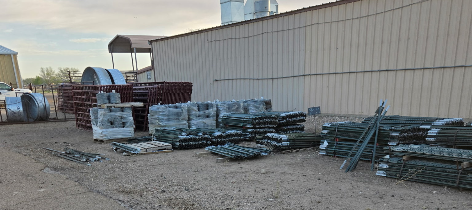 United Supply Inc. store front with stacked steel and supplies.